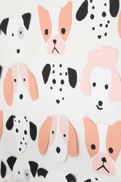 paper cut outs with dogs on them are hanging from the wall in front of a white background