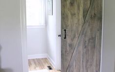 an open wooden door in a white room