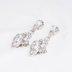 Add a dash of sparkle with our NAZ Swarovski Drop Earrings, the daintier version of our IDIL Drop Earrings! Inspired by tear drop shaped crystals in different sizes to add a lasting touch to every look. These will look fashionable with a casual look or a night out paired with your favorite dress and heels. They are meant to become your earrings of choice for high-style event. Handcrafted with the Highest Quality Materials Swarovski Crystals Platinum plated - Guards against scratches and tarnish. Swarovski Drop Earrings, Crystals Earrings, Shaped Crystals, Boutique Couture, Swarovski Crystal Earrings, Earrings Wedding, Wedding Jewelry Sets, Gold Drop Earrings, Dress And Heels