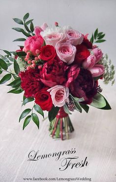 a bouquet of red and pink flowers on a table