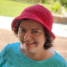 a woman wearing a red hat and smiling