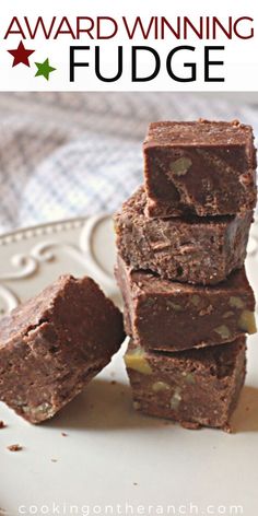 four pieces of fudge sitting on top of a white plate with the words, award winning fudge