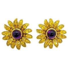 Hello Sunshine!! 18 karat yellow gold Sunflower earrings . Each of the 14 petals have been meticulously set with round brilliant cut Yellow Sapphires. The center of the flower is set with a cabachon Amethyst in a bezel setting. Each earring measures 1.25". The earrings are clip on, but a post can be added. Total Yellow Sapphire weight 10.90 carats Total Amethyst weight 7.60 carats Signed Jean Vitau 18KP Signed Jean Vitau 1994 18K Formal Yellow Gold Flower Earrings With Prong Setting, Formal Yellow Flower-shaped Earrings, Purple Palette, White Gold Hoop Earrings, Gold Chandelier Earrings, Cognac Diamonds, White Gold Hoops, Contemporary Earrings, Sunflower Earrings