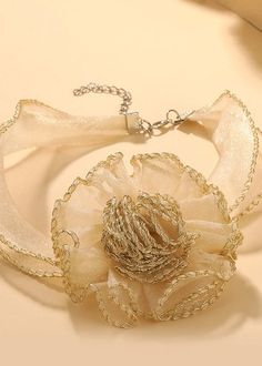 This elegant choker features a stunning 3D flower design, made with delicate organza material and finished with intricate edging. Adding a touch of femininity to any outfit, the beige color complements any skin tone. Perfect for both formal and casual occasions. *Return & Exchange are not supported Chic Choker For Spring Gift, Chic Cream Jewelry For Party, Flower Shaped Choker For Spring Party, Elegant Wedding Ribbon Choker, Elegant Wedding Choker With Ribbon, Floral Choker For Spring Parties, Summer Party Flower Shaped Choker, Elegant Cream Jewelry For Summer, Elegant Adjustable Cream Choker