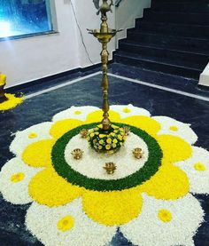 a decorated floor with flowers and candles in the shape of a sunflower on it