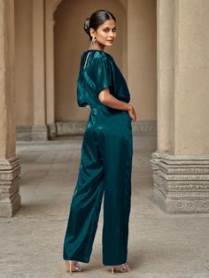 This soft satin jumpsuit features a flattering v-neck design, making it the perfect choice for mothers of the bride. Its dress pantsuit style provides comfort and elegance, while its high-quality material ensures a polished look. Stay stylish and comfortable on that special day with our jumpsuit. Elegant Satin Pantsuit For Evening, Elegant V-neck Evening Pantsuit, Elegant Satin Jumpsuits And Rompers For Workwear, Elegant V-neck Pantsuit For Formal Occasions, Elegant Satin Jumpsuit Or Romper In Solid Color, Formal Satin V-neck Jumpsuit, Satin V-neck Jumpsuits And Rompers For Party, Satin Jumpsuit With V-neck For Party, Elegant Silk V-neck Jumpsuits And Rompers