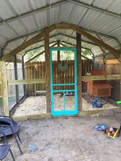 the inside of a chicken coop with blue doors