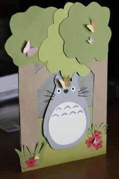 a card with a totoro and butterflies on it