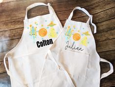 two personalized aprons are sitting on a table