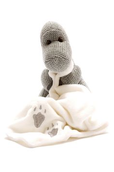 a stuffed animal sitting on top of a blanket