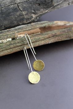 These lovely and simple earrings are made from hammered Brass circles with sterling silver ear wires. Simple enough for everyday wear, but enough to add a little pop! The earrings dangle 1.75 inches from the ear. Traditional Cheap Metal Earrings, Minimalist Everyday Linear Earrings With Hammered Detail, Minimalist Hammered Sterling Silver Linear Earrings, Everyday Minimalist Hammered Linear Earrings, Minimalist Hammered Dangle Linear Earrings, Minimalist Hammered Dangle Earrings, Minimalist Hammered Round Disc Earrings, Minimalist Hammered Long Drop Earrings, Minimalist Round Earrings With French Hook