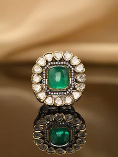 Embark on a journey of unmatched sophistication with our distinctive ring, showcasing the exquisite Kundan Polki set against a lavish backdrop of 22kt gold plating. This extraordinary creation seamlessly weaves together the rich tapestry of tradition and contemporary aesthetics, resulting in a poetic harmony. Grace yourself with this embodiment of refined elegance – a tribute to individuality and timeless charm that goes beyond fleeting trends. Finish: 22KT Gold Plating Material: Brass, Kundan, Elegant Ceremonial Festive Rings, Traditional Emerald Jewelry For Anniversary, Elegant Gold Rings For Festivals, Elegant Festive Ring With Intricate Design, Elegant Green Ceremonial Rings, Festive Heirloom Jewelry With Intricate Design, Gold Emerald Ring Hand Set As A Gift, Opulent Gemstone Jewelry For Anniversary, Opulent Jewelry For Gifts With Intricate Design