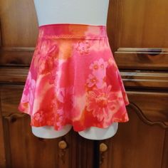 This pull on skirt is made from a coral, orange, pink Hawaiian print spandex.  XS size fits waist 25-27.  Hips 34-36 inches.  Front length 10 inches.  Back length 12 inches.  Free first class shipping within USA.  This print is also available in my shop in XXS, S and Med. Orange Skirted Skort For Spring, Spring Orange Skirted Skort, Spring Multicolor Stretch Swim Skirt, Fitted Pink Lined Swim Skirt, Pink Stretch Lined Swim Skirt, Pink Fitted Short Swim Skirt, Fitted Pink Short Swim Skirt, Pink Stretch Skort With Elastic Waistband, Pink Floral Print Skort