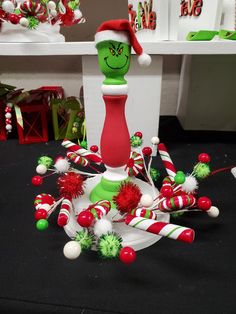 the grin face is sitting on top of candy canes