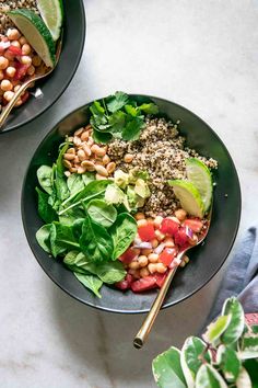 two bowls filled with different types of salads on top of a white countertop