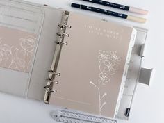 an open planner book sitting on top of a desk next to two pencils and a ruler