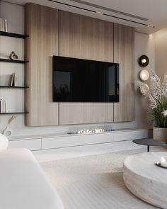 a modern living room with white furniture and large tv mounted on the wall above it