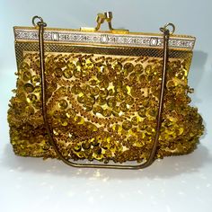 Vintage Delill Evening Bag In Excellent Unused Condition, Like New. No Damage Or Signs Of Use Or Wear. The Interior Liner Is Free From Any Flaws - There Are No Stains Or Discoloration. It Is Truly Flawless And Exceptional For Its Age. The Bag Is Hand Beaded With Gold Glass Beads And Sequins. It Has White And Gold Ornate Detailing Across The Top And A Metal Chain Top Handle. The Interior Is Lined With A Light Colored Satin Fabric. Width: 7.5” Height: 5” Offers & Bundles Welcome! Discounts!!! **** Gold Sequined Bags As Gifts, Gold Sequined Bags For Gifts, Gold Sequin Bags For Gifts, Luxury Gold Sequin Bag, Elegant Gold Bags With Sequins, Elegant Gold Sequined Shoulder Bag, Elegant Gold Sequined Bags, Gold Sequined Shoulder Bag For Evening, Luxury Gold Beaded Evening Bag