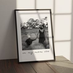 an image of a mother and her child holding hands on a table in front of a window