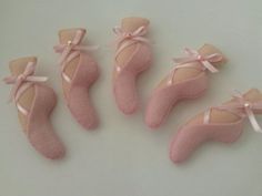 four pairs of pink ballet shoes with bows