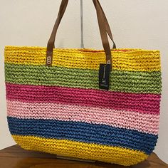 So Bright Now: Go From The Beach To Brunch In Fun, Colorful Style With I.N.C. International Concepts' Capacious Tote In A Sunny Striped Woven. Extra-Large Sized Bag; 20-1/2"W X 14-2/10"H X 4/10"D (Width Is Measured Across The Bottom Of Bag); .83 Lbs. Approx. Weight 9-1/10"L Double Handles Magnetic-Snap Closure 1 Interior Zip Pocket & 2 Slip Pockets Laptop Compatible (Std. Size 13"-15") Paper; Trim: Faux Leather Casual Straw Shopping Bag For Spring, Multicolor Straw Bag For Travel And Beach Season, Multicolor Straw Bag For Beach Season Travel, Multicolor Straw Bag For Beach Travel, Casual Striped Rectangular Straw Bag, Casual Multicolor Shoulder Bag For Shopping, Multicolor Straw Bag For Everyday Vacation Use, Colorful Beach Bag With Adjustable Strap, Colorful Beach Shoulder Bag With Adjustable Strap