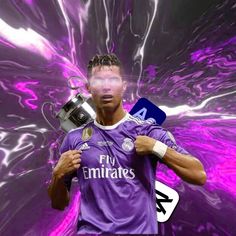 a man holding a soccer trophy in front of a purple background