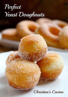 three sugar coated doughnuts on a plate with the words perfect yeast doughnuts written below