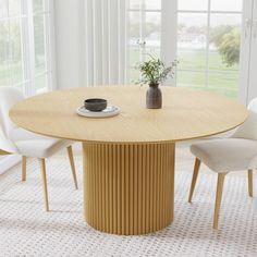 a wooden table with white chairs and a potted plant sitting on top of it