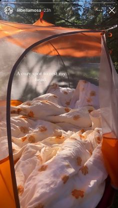 an orange and white tent with the words cozy spot for my head written on it