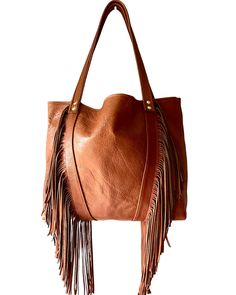 This gorgeous fringe tote is an absolute classic.  It measures 14 inches wide, 11 inches in height and has a depth of 4 inches. There is an interior pocket for your smaller items.  Handmade from my studio in Greenville, South Carolina. Chic Brown Fringe Hobo Bag, Chic Tote Shoulder Bag With Tassels, Chic Tassel Tote Shoulder Bag, Tassel Hobo Bag For Shopping, Luxury Shoulder Bag With Fringe, Chic Rectangular Hobo Bag With Fringe, Luxury Top Handle Shoulder Bag With Fringe, Luxury Leather Shoulder Bag With Fringe, Chic Rectangular Fringe Hobo Bag