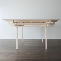 the table is made out of wood and has three sections on each side that are connected to one another