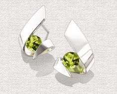 Peridot Earrings - Argentium Silver - 2440 A contemporary, yet timeless design by award winning designer, David Worcester. PLEASE LOOK AT THE MEASUREMENTS CAREFULLY. Some photos have been enlarged to show detail, while others have been minimized to fit the frame. Actual size cannot be determined from the photographs. MEASUREMENTS AND MATERIALS: Cast in Argentium 960 premium quality 100% recycled silver, these earrings, specially processed for tension setting, measure 19mm x 14mm, or 3/4 x 5/8 in Green Modern Sterling Silver Earrings, Modern Green Sterling Silver Earrings, Modern Green Earrings For May Birthstone, Modern Green May Birthstone Earrings, Modern Green Earrings For Anniversary, Modern Green Earrings With Polished Finish, Contemporary Green Sterling Silver Jewelry, 16th Wedding Anniversary, Yucca Valley