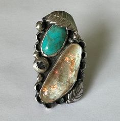 "this is a phenomenal piece, a ring that goes most of the way up my short finger.  it has a bright turquoise and a large cabochon of dichroic glass midst wonderful southwestern details.  leaves and scallops and silver beads decorate the face.  the band is split and wide to support the considerably large and weighty face.  inside is marked 925 with a stamp as signature.  this was nicely made and sized beautifully.  at some angles it looks like there are cracks in the glass, those are just veins o Ruby Ring Gold, Crescent Moon Earrings, Bright Turquoise, Southwest Jewelry, Vintage Bell, Dichroic Glass, Moon Earrings, Ruby Ring, Favorite Rings