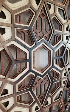 an intricately designed wooden wall with many different shapes and sizes on the sides, including hexagonals