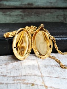 This is a vintage 1960s double chain locket necklace, marked Park Lane on a metal tag. It is a gold tone metal. There is one short chain and one long chain. The shortest chain is 16 in., and the longest chain is 24 in. long. The oval locket is 1 3/4 in. long, and 1 1/8 in. wide, without the bail. The necklace is in great condition. Thank you for looking! Gold-tone Locket Chain Necklace As Gift, Gold-tone Chain Necklace With Locket For Gift, Gold Brass Locket Chain Necklace, Gold Brass Chain Necklace With Locket, Gold Locket Necklace With Adjustable Chain, Gold Metal Locket Necklace With Vintage Charm, Antique Gold Metal Locket Necklace, Retro Gold Jewelry With Adjustable Chain, Vintage Gold-tone Locket Necklaces