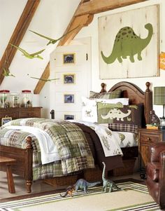 a child's bedroom decorated in green and white with dinosaurs on the bedding