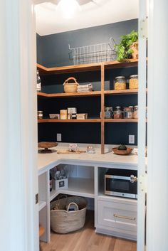 an open pantry with shelves and baskets