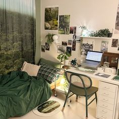 a bedroom with a bed, desk and computer on the wall next to a window