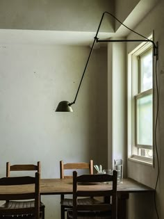 a table with chairs and a lamp hanging over it