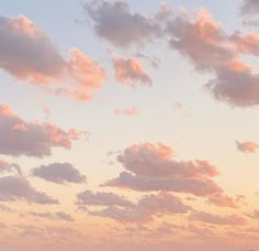 two airplanes are flying in the sky at sunset or dawn with clouds and mountains behind them