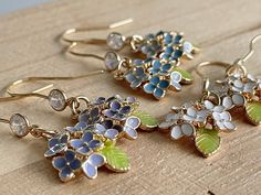 These tiny Hydrangea flower earrings are dainty and finely made with intricately details.  They are a delightful jewelry for yourself or a thoughtful gift for friends, mothers and lovers. DETAILS: ❇️ Hydrangea Flower: H16 x W13mm, gold plated over brass with enamel ❇️Earring Hooks: gold plated over brass with 4mm cubic zirconia ❇️ Quantity: 1 pair 💛OTHER STYLES 💛 https://atelierdecielbleu.etsy.com/listing/1531301555 💛NECKLACE 💛 https://atelierdecielbleu.etsy.com/listing/1531345251 【IMPORTANT French Hydrangea, October Jewelry, Flower Earrings Gold, Enamel Earrings, Earring Hooks, White Enamel