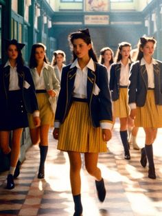 a group of young women walking down a hallway next to each other in school uniforms