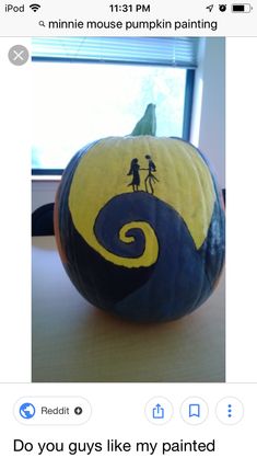 a pumpkin painted with the silhouettes of two people on it