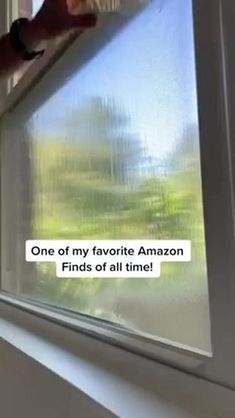 a woman is looking out the window with an expression that reads, one of my favorite amazon finds of all time