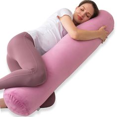 a woman laying on a pink pillow with her arms crossed and head resting on the pillow