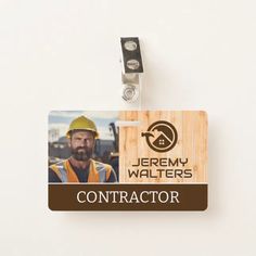 the name tag for a construction worker is attached to a keychain with an image of a man wearing a hardhat