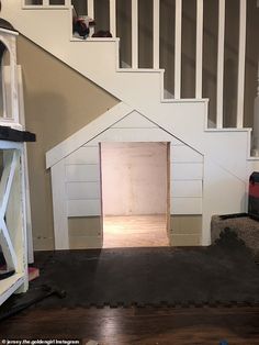 a dog house built into the side of a staircase