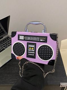 Introducing the Radiant Melody: Purple Radio Handbag, a trendy music-inspired crossbody bag. With its stylish design and convenient crossbody strap, this bag is perfect for carrying all your essentials while adding a touch of music to your outfit. Made from high-quality materials, it is both durable and fashionable. Elevate your fashion game with this must-have accessory. Color : Purple Details : Chain, Spiked Type : Novelty Bag, Square Bag, Box Bag, Camera Bag Bag Size : Mini Closure Type : Buc Trendy Rectangular Bag For Concerts, Trendy Portable Purple Shoulder Bag, Trendy Rectangular Shoulder Bag For Concert, Trendy Rectangular Shoulder Bag For Concerts, Trendy Shoulder Bag For Concerts, Retro Portable Crossbody Shoulder Bag, Portable Retro Crossbody Shoulder Bag, Crossbody Bag With Adjustable Strap For Concerts, Trendy Music