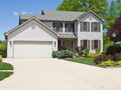 a large white house with the words rady construction concrete driveways in front of it