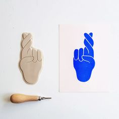 a stamp with a peace sign on it next to a piece of paper that has a hand print